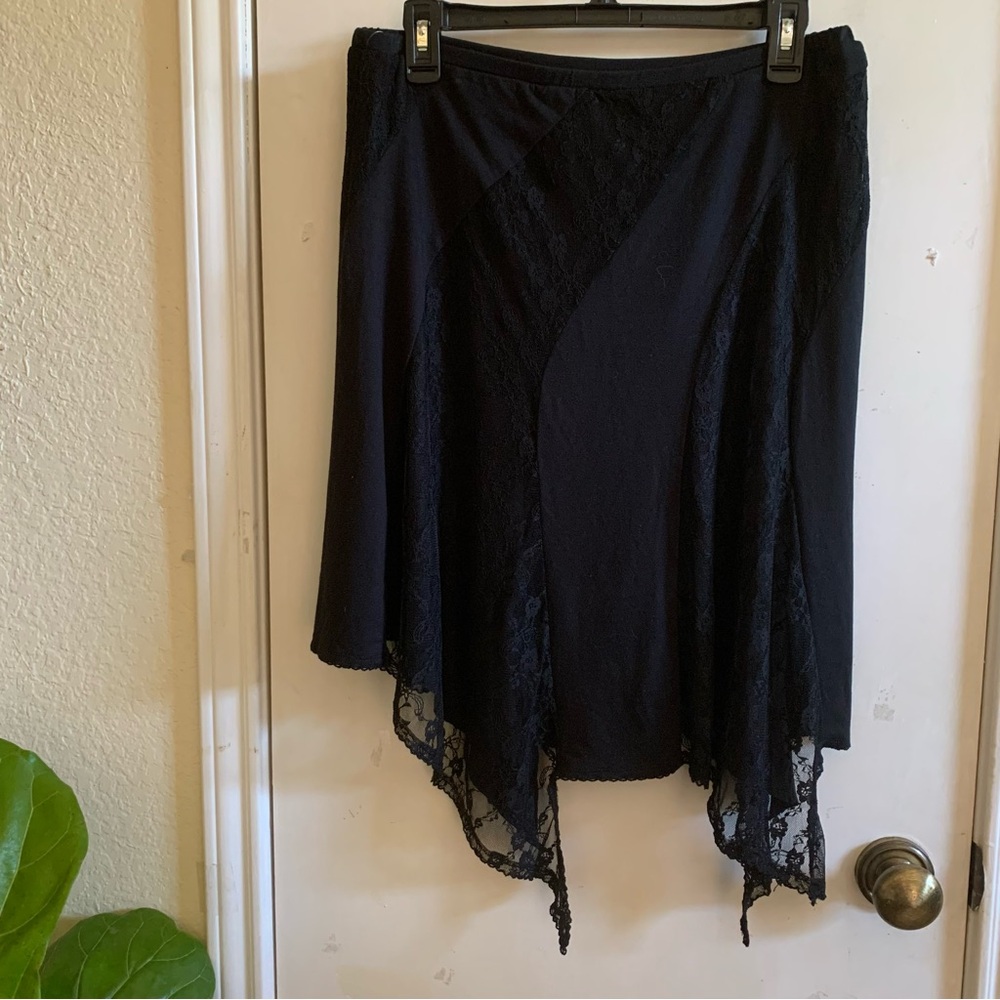 Brand NWOT Free People Elegant Black acymmetrical Lace Trim Skirt size M.